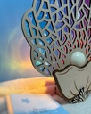 Veilleuse coquillage en bois allumée diffusant une lumière douce pour le coucher - Le Coffre aux Étoiles